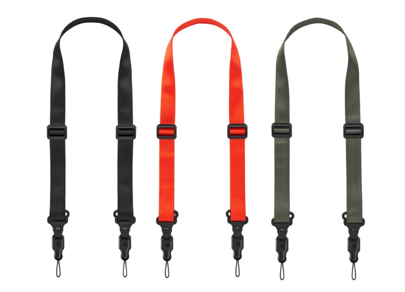 Three adjustable camera straps in black, red, and olive green are displayed vertically side by side, each with plastic clips and loops for attachment at both ends.