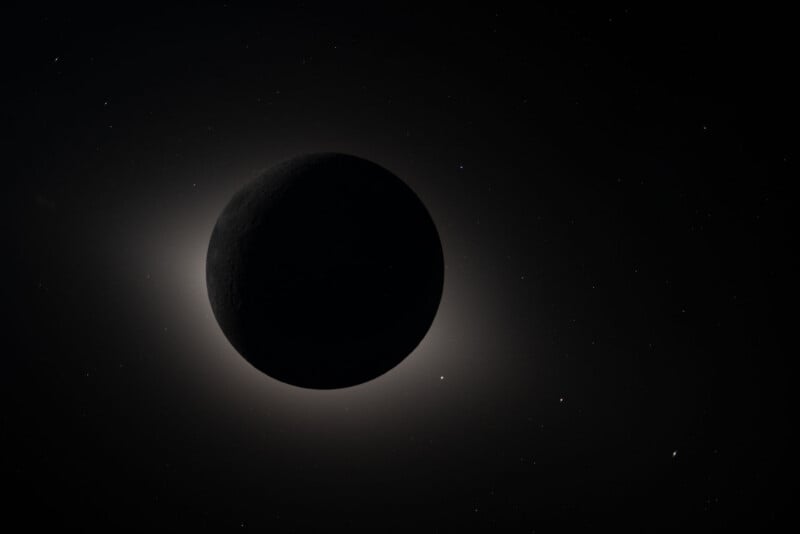 A dark celestial body, possibly a planet or moon, is silhouetted against a faint glowing halo, with a field of small stars scattered across the dark background.