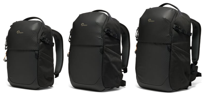 Three black Lowepro backpacks of varying sizes are displayed side-by-side against a white background.