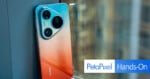 Huawei smartphone with a gradient red-to-blue back and triple camera setup leans against a window; 