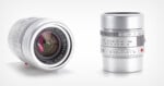 Two silver camera lenses are shown: one standing upright displaying its focus and aperture markings, the other lying on its side, showing its glass element and lens branding 