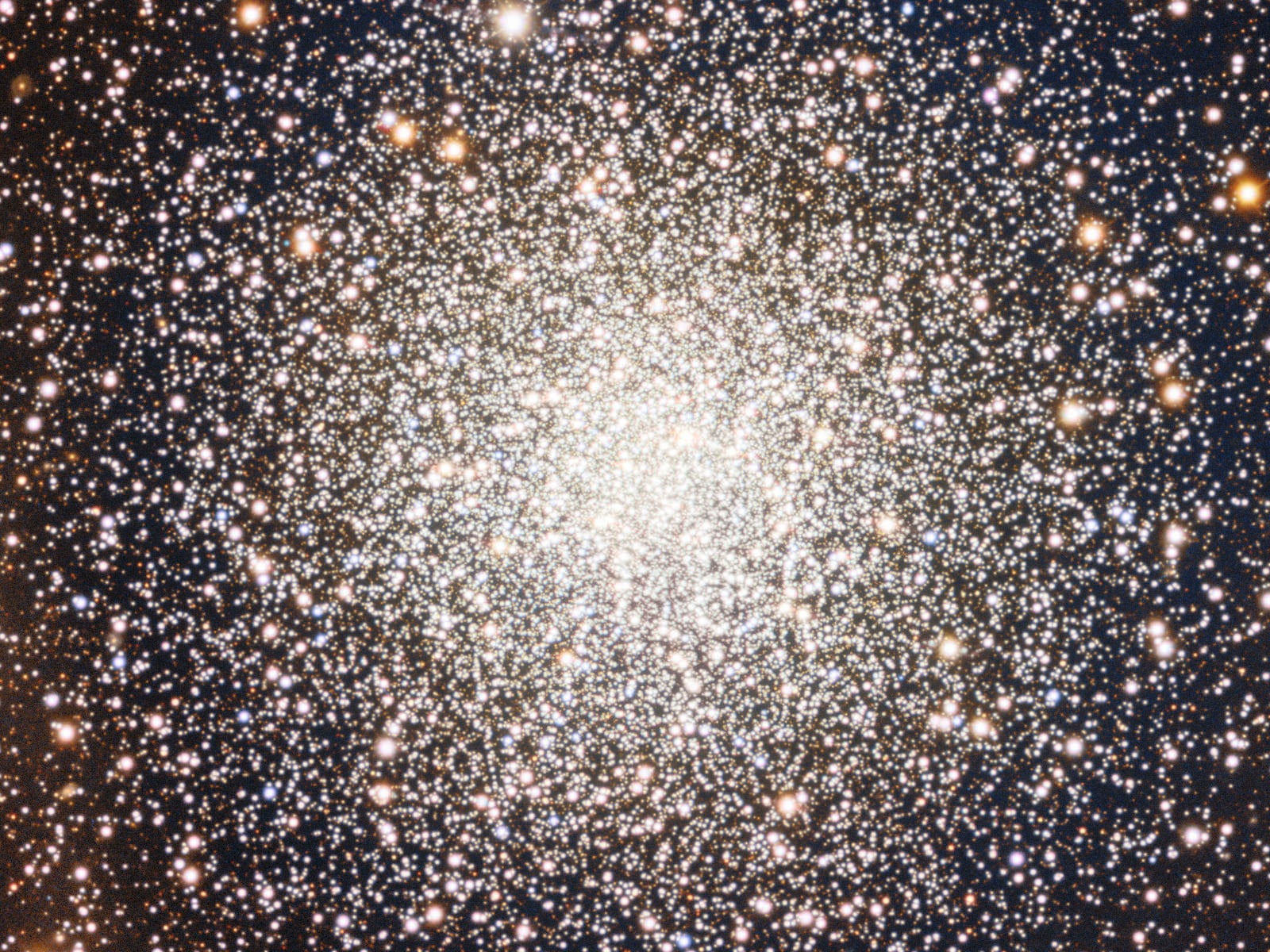 A dense cluster of hundreds of bright stars with a glowing center, surrounded by darker space and scattered with smaller, dimmer stars.