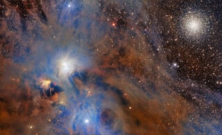 Colorful nebula with blue and orange gas clouds, bright stars, and a dense, spherical star cluster on the right side against a dark space background.