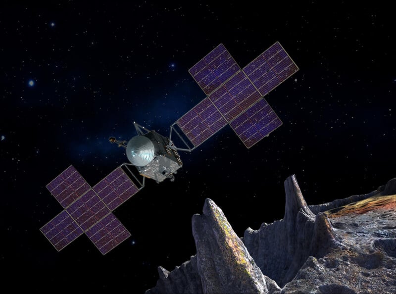 A spacecraft with large solar panels orbits above a rocky, cratered surface in deep space, with stars visible in the background.