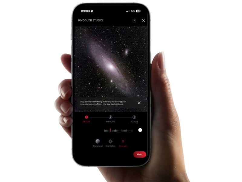 A hand holds a smartphone displaying the Skycolor Studio app, which shows an image of a galaxy being edited with a slider set to a strength of 11.