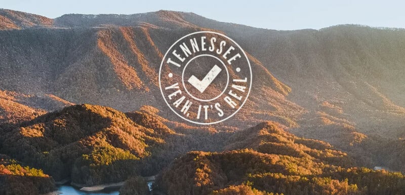 A scenic mountain landscape at sunset with "Tennessee Yeah, It's Real" and a checkmark logo overlaid in white text at the center of the image.