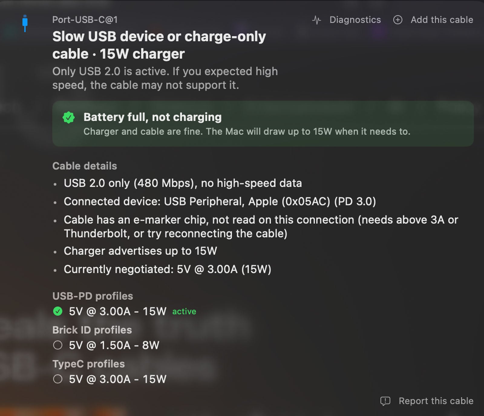 A computer screen displays a system dialogue showing a USB-C port’s charging details, indicating a slow 15W maximum output with “Battery full, not charging.” Technical specs about cable and power delivery are listed.