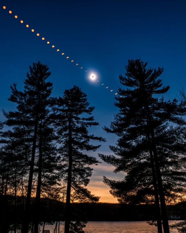 A composite image shows the progression of a solar eclipse across a twilight sky above silhouetted pine trees and a lake.