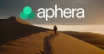 A person walks along the ridge of a sand dune at sunset, with the word 