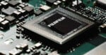 A close-up view of a black square computer chip labeled 