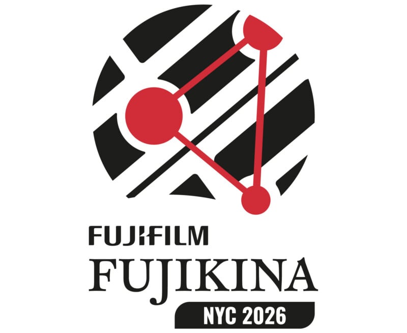 A logo featuring a black circle with white diagonal stripes, overlaid with a red triangle connecting three red circles, above the text "FUJIFILM FUJIKINA NYC 2026".
