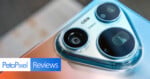 A close-up view of a smartphone camera module with three lenses and the text 