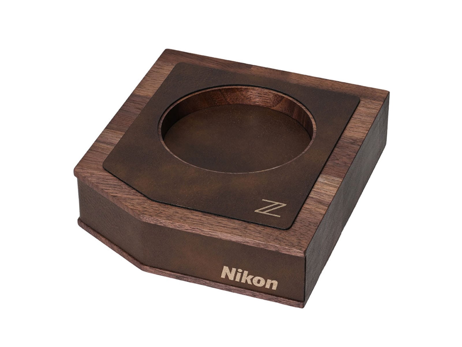 A wooden display stand featuring a circular cutout, a leather-like top surface with a "Z" logo, and the word "Nikon" printed on the front side.