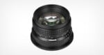 A black Pergear camera lens viewed from a high angle, showing its focus and aperture rings with white and green markings.