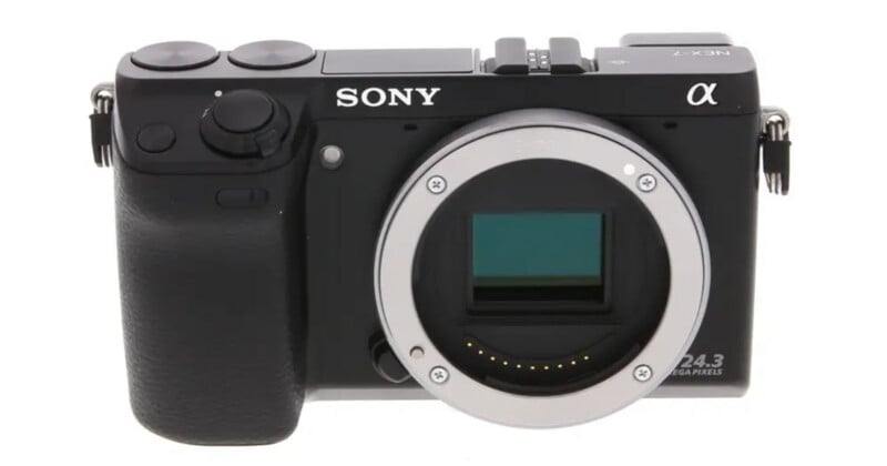 A black Sony NEX-7 mirrorless camera body is shown from the front, featuring an E-mount lens opening and a 24.3 megapixel label.