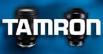 Two camera lenses are positioned against a blue background with the word TAMRON written in large white letters across the center.