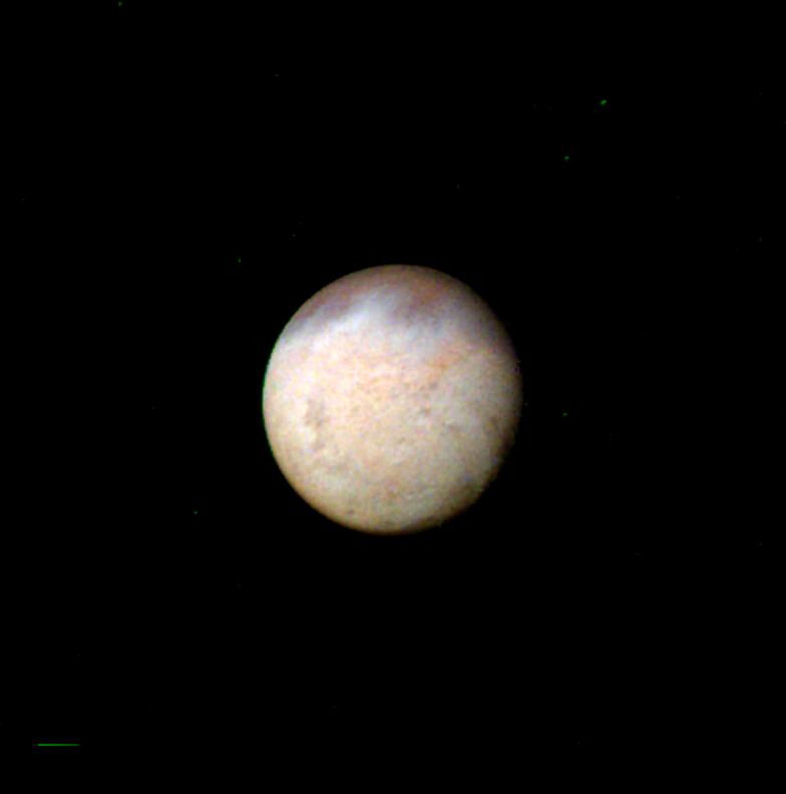 A spherical, textured celestial body with mottled tan and white coloring is centered against a black background.