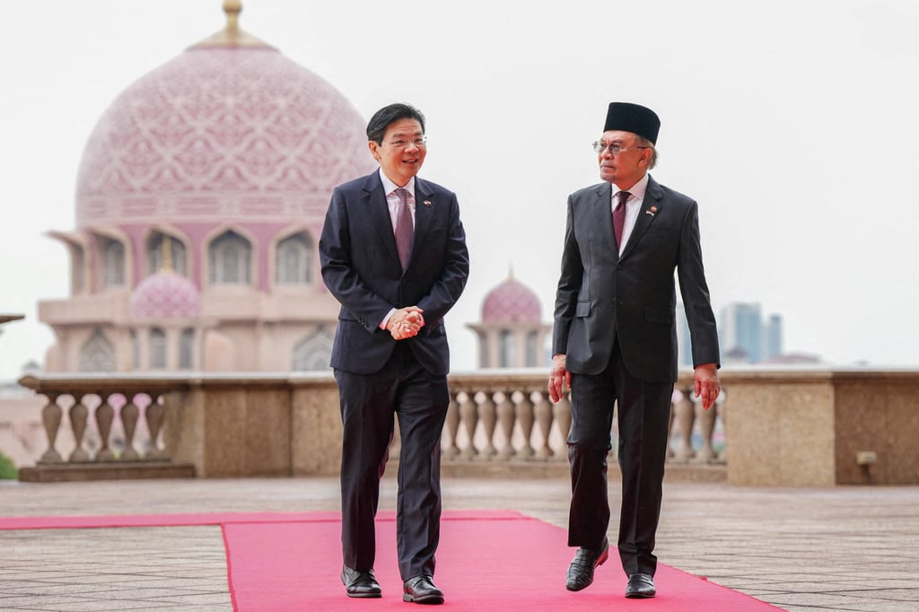 Singapore’s Prime Minister Lawrence Wong walks with his Malaysian counterpart Anwar Ibrahim in Putrajaya, Malaysia, on January 7. Singapore and Malaysia signed an agreement to develop the 3,500 sq km Johor-Singapore Special Economic Zone. Photo: Pool via Reuters