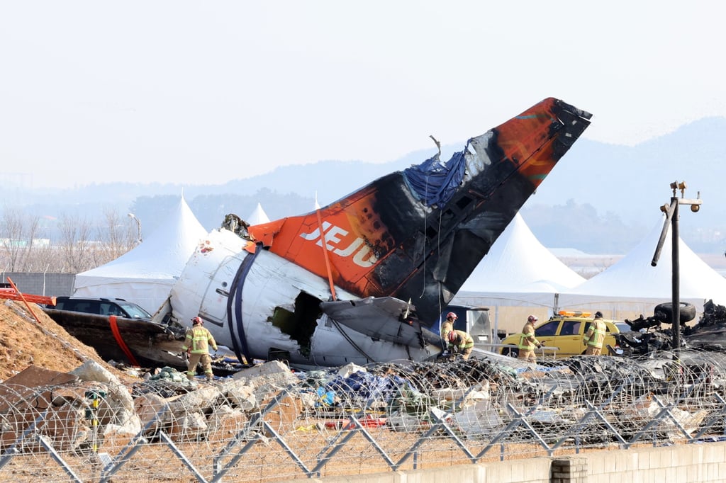 Firefighters work to clear the debris of Jeju Air Flight 2216 on January 13, days after it crashed at the Muan International Airport. Photo: EPA-EFE