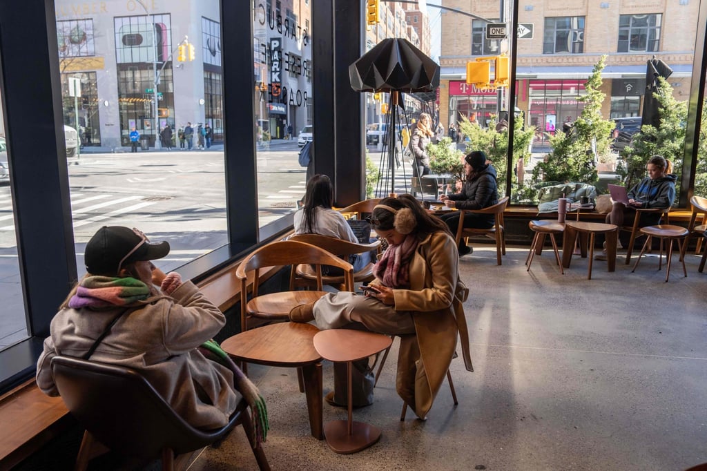 People sit inside of a Starbucks in New York City. Photo: AFP