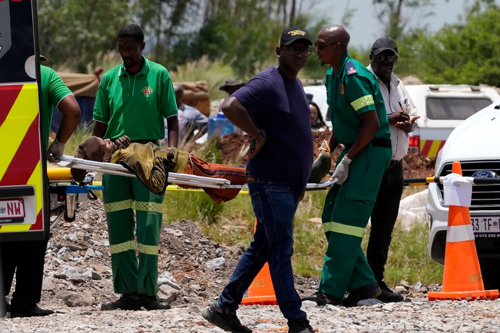 A miner being carried on a stretcher. Photo: AP