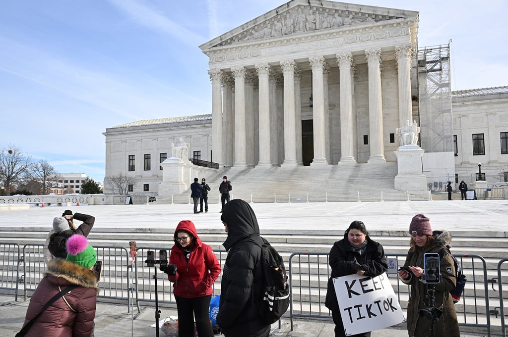 TikTok supporters live stream outside the US Supreme Court during oral arguments in the case in Washington on Friday. Photo: Getty Images/TNS