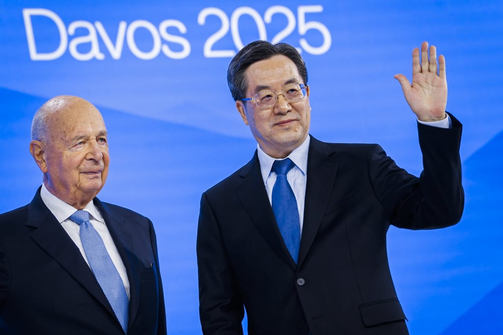 World Economic Forum founder Klaus Schwab (left) on stage with Ding Xuexiang. Photo: EPA-EFE