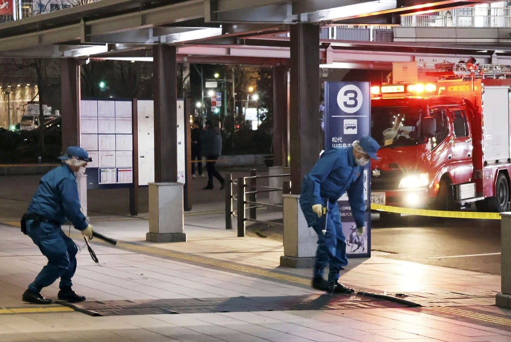 Members of police exam the scene of a multiple stabbing in front of JR Nagano station. Photo: AP