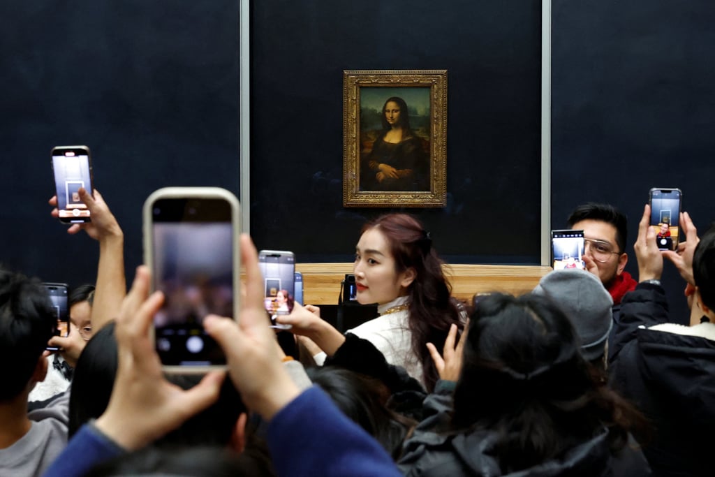 Visitors take pictures of the Mona Lisa on Thursday. Photo: Reuters