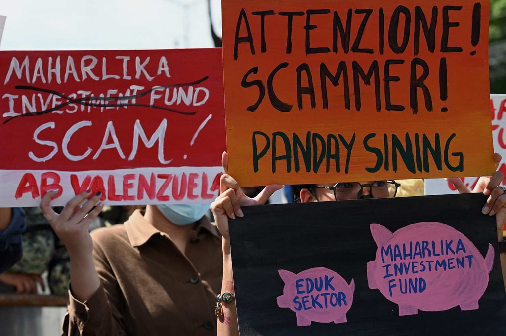 People hold signs during a protest at Mendiola in Manila on July 18, 2023 to condemn the passing into law of the Mahalika sovereign wealth fund. Photo: AFP