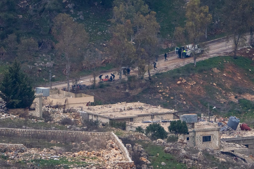 Emergency services evacuate people wounded by gunshots near the village of Odaisseh in southern Lebanon. Photo: AP
