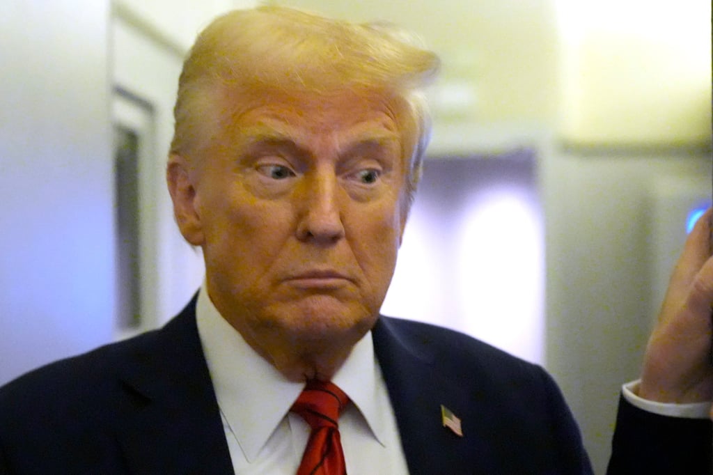 President Donald Trump speaks to reporters on board Air Force One en route from Miami to Joint Base Andrews in Maryland on Monday. Photo: AP