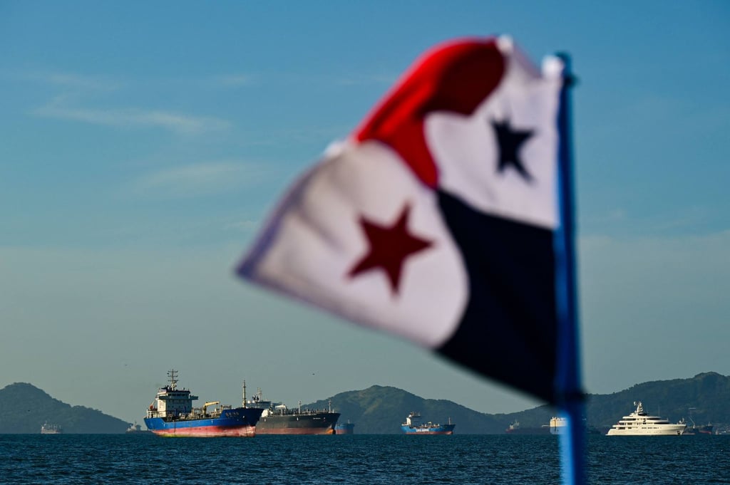 A Panamanian flag is pictured in front of cargo ships waiting to enter the Panama Canal. Photo: AFP