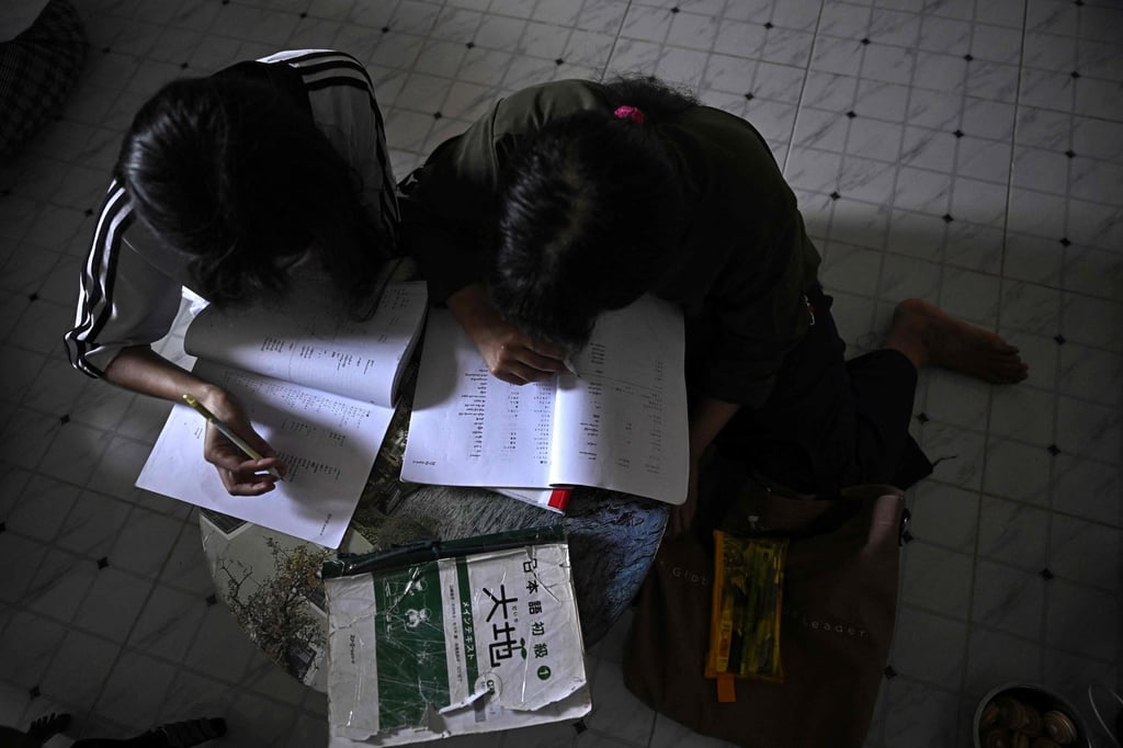 A Myanmar migrant worker learns Japanese at a makeshift school inside a fellow Myanmar worker’s flat. Photo: AFP