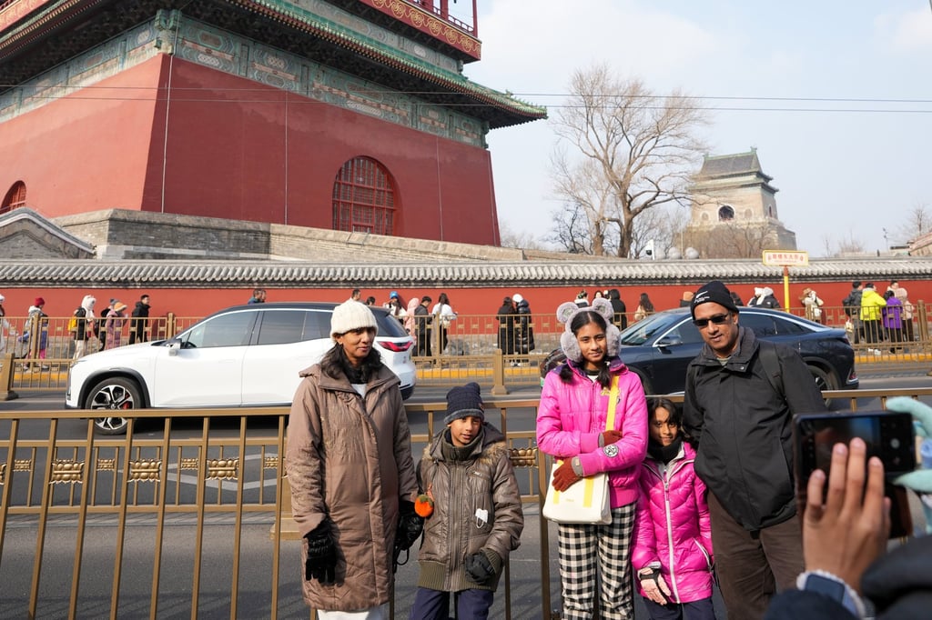 A family from Malaysia poses for photos in Beijing on Friday. Photo: Xinhua