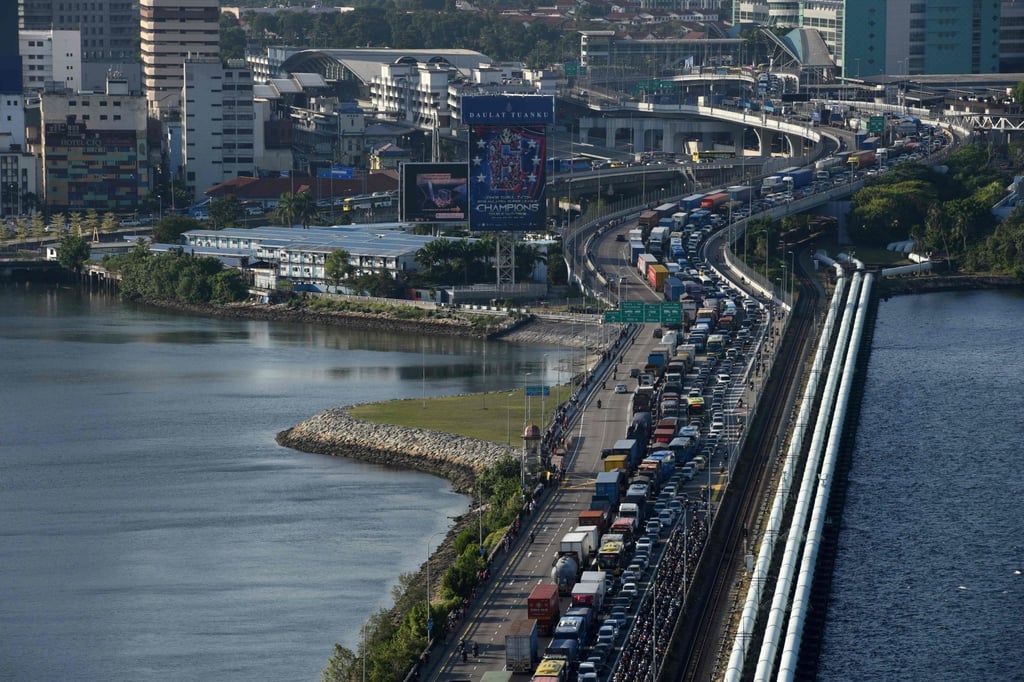 Vehicles form a long queue to enter Singapore from the southern Malaysian state of Johor across the causeway. Photo: AFP