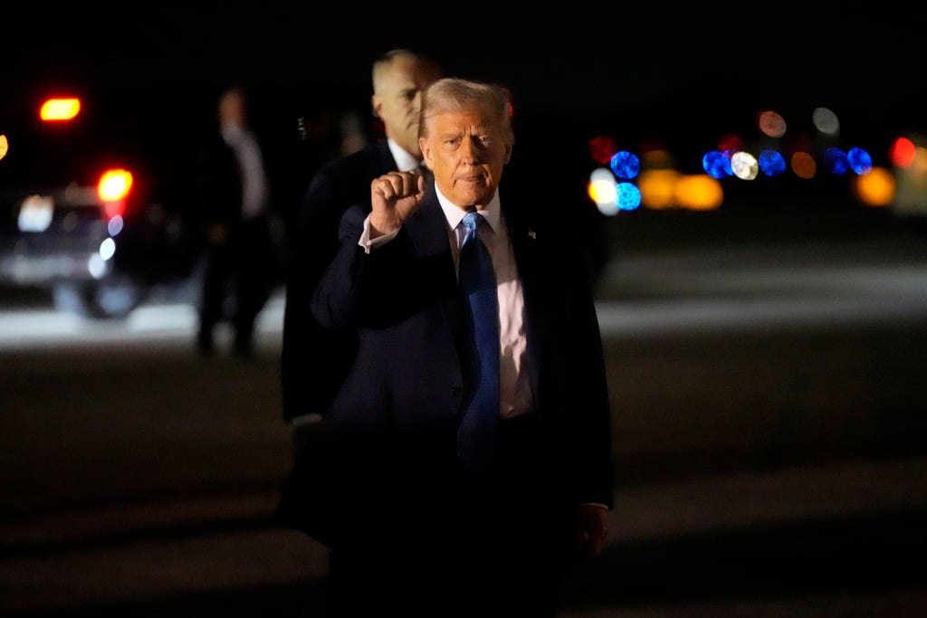 President Donald Trump gestures as he arrives at Palm Beach International Airport en route to his Mar-a-Lago estate in Palm Beach. Photo: AP