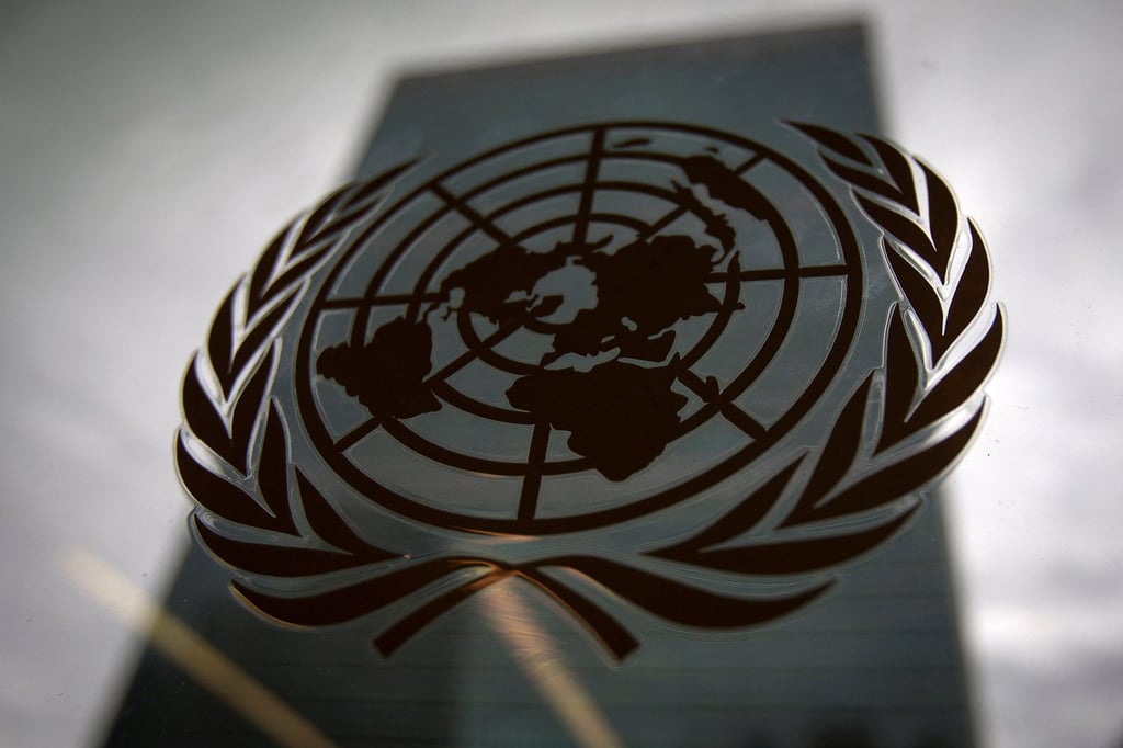 The United Nations headquarters in New York is pictured though a window with the UN logo in the foreground. Photo: Reuters