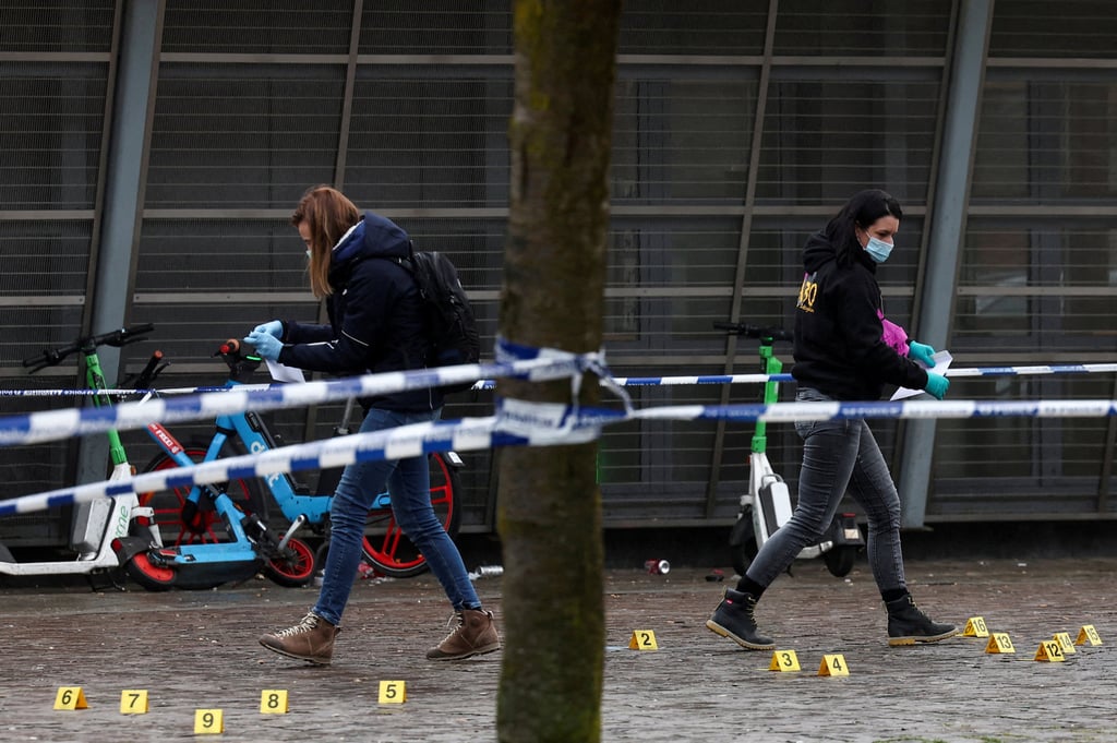 Members of the forensic police work at the Clemenceau metro station after the shooting. Photo: Reuters