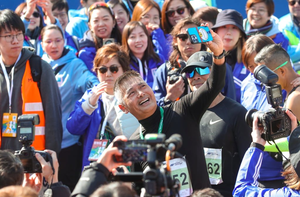 Film star Chow Yun-fat posing with other runners. Photo: Edmond So