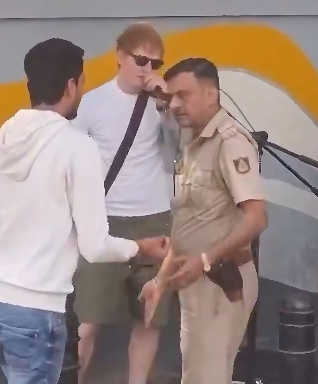 Ed Sheeran reacts after an Indian policeman unplugged his microphone amid an impromptu street performance in Bengaluru on Sunday. Photo: X/aaraynsh