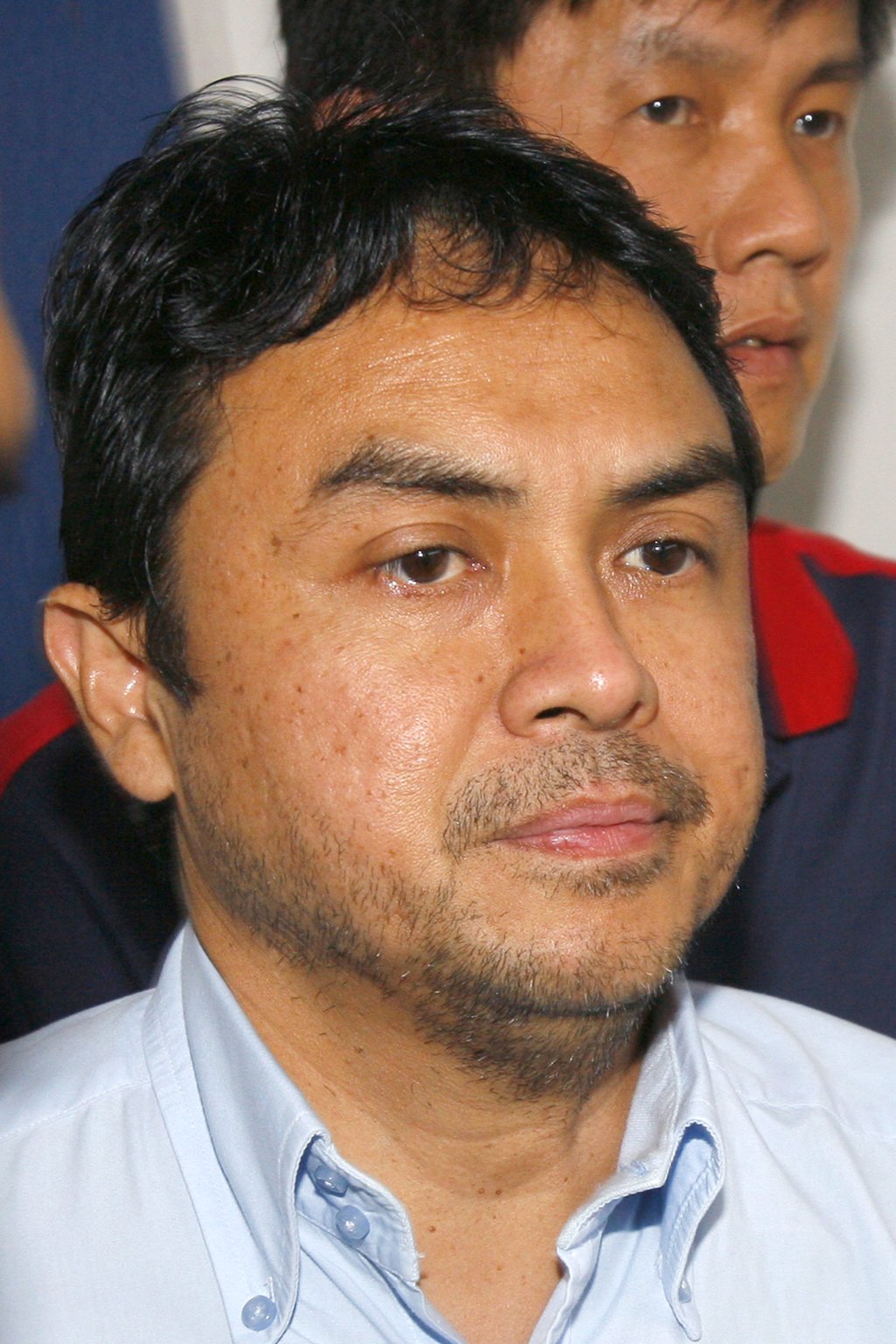 Abdul Razak Baginda is escorted out of a police station in Kuala Lumpur in 2006. Photo: AFP