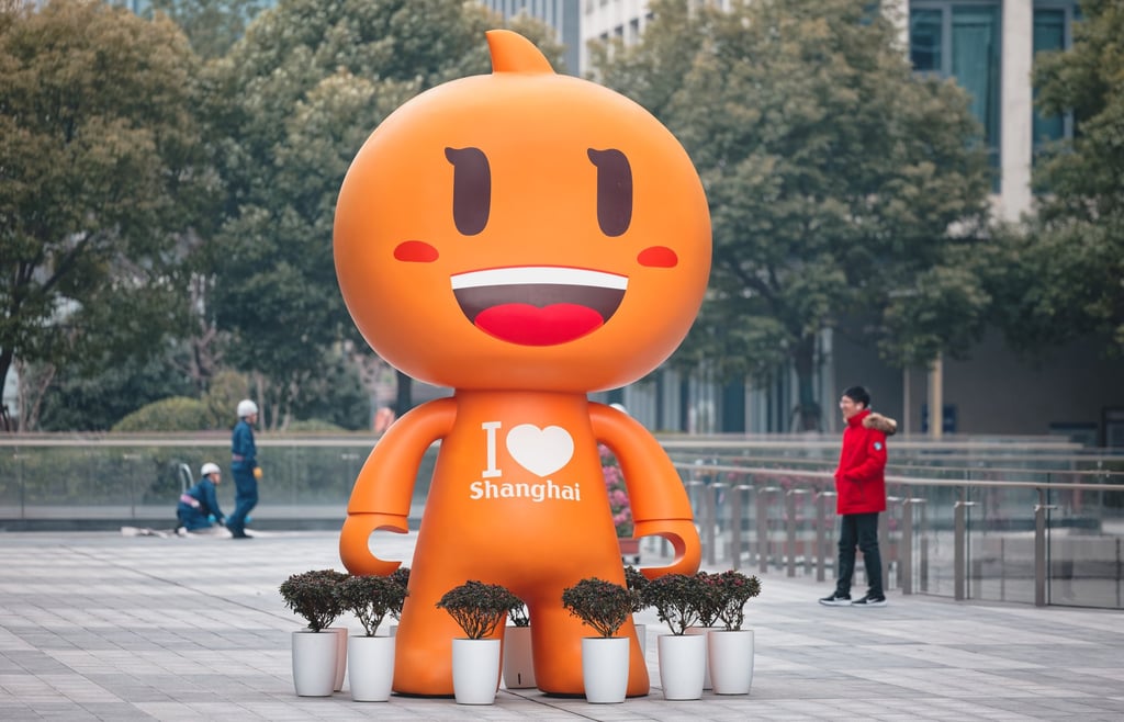 People walk past the Alibaba mascot in front of the Alibaba Centre in Shanghai on February 12. Photo: EPA-EFE