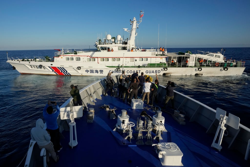 Journalists report as a Chinese coastguard ship blocks the path of the Philippine coastguard’s BRP Sindangan trying to enter the Second Thomas Shoal in the disputed South China Sea on March 5, 2024. Photo: AP