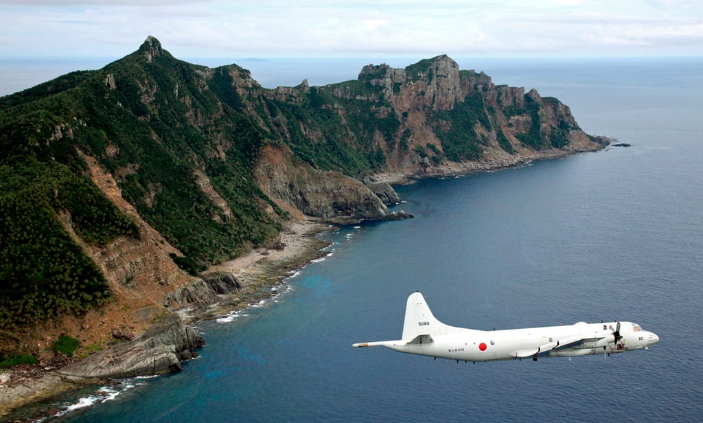 A Japanese surveillance plane flies over disputed islands in the East China Sea. Photo: Kyodo/AP
