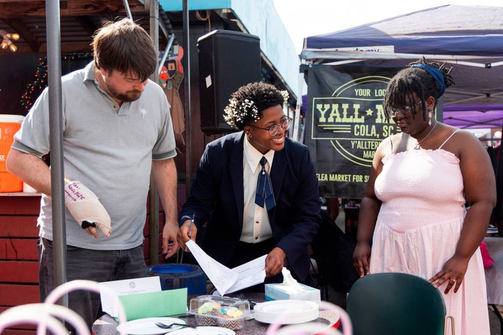 Mahkia Greene and Klo Hampton sign their marriage licence at Y’all-Mart, a quarterly art fair series, at Art Bar in Columbia, South Carolina, on February 9, 2025. Photo: TNS