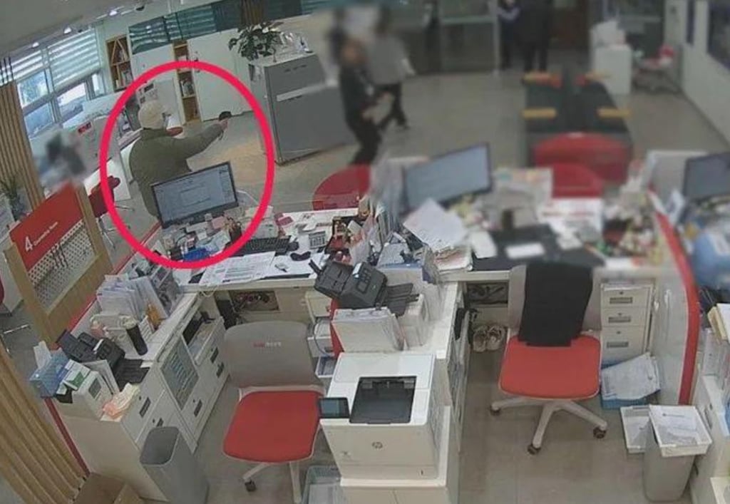 The hapless robber points the toy gun, concealed in a plastic bag, at customers and staff. Photo: Douyin