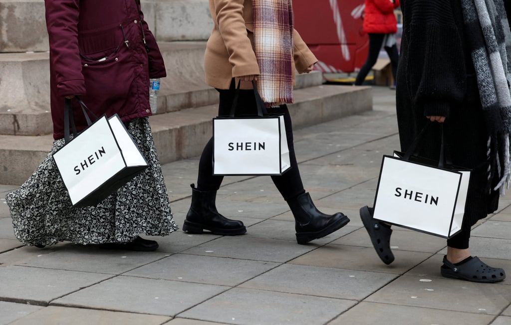 Shoppers in Manchester, Britain, carry bags from fashion retailer Shein. Photo: Reuters