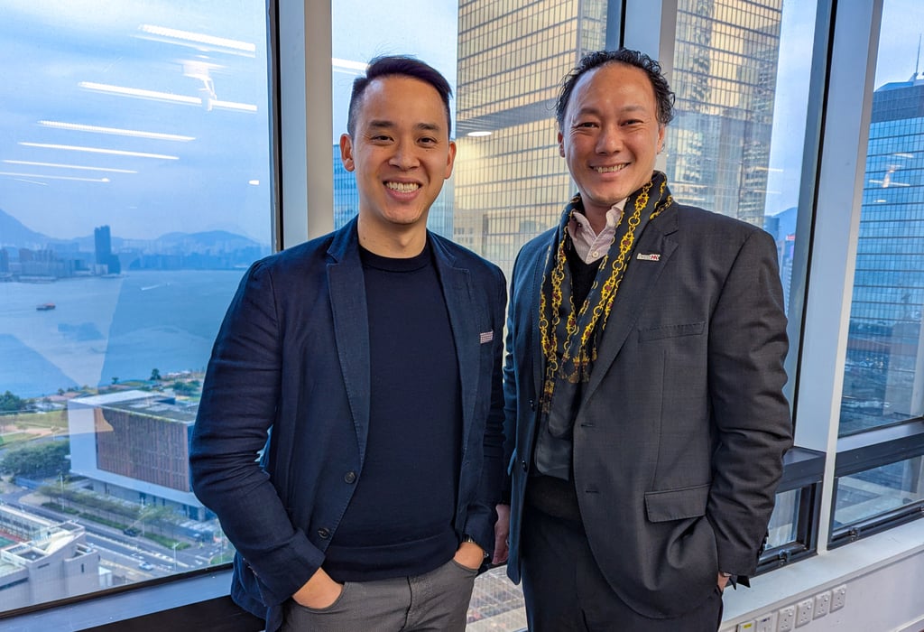 Consensus Hong Kong chairman Michael Lau (left) with InvestHK head of financial services and fintech King Leung at the InvestHK offices in Central on February 13. Photo: Matt Haldane