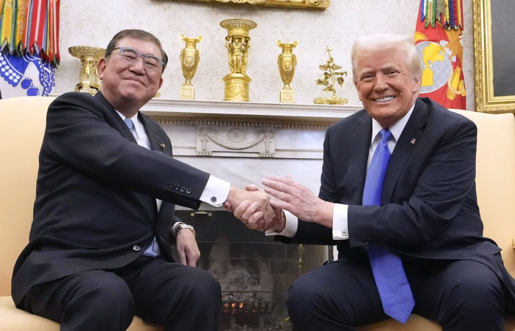 Japanese Prime Minister Shigeru Ishiba shakes hands with US President Donald Trump at the White House in Washington on February 7. Photo: Kyodo
